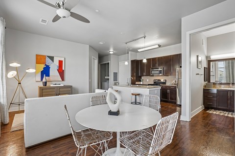 A modern kitchen with a dining table and chairs.
