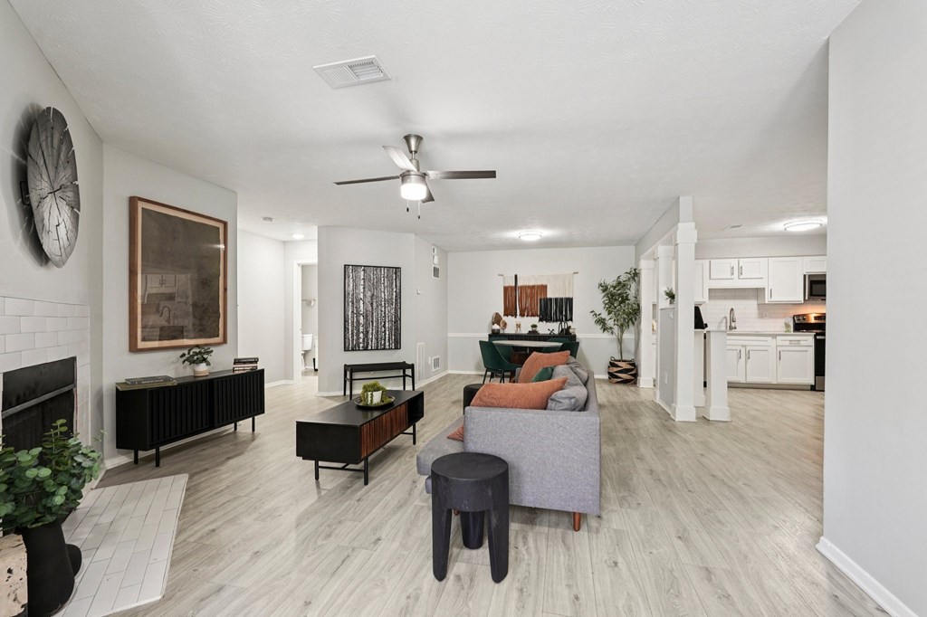 A living room with a fireplace and a painting on the wall.