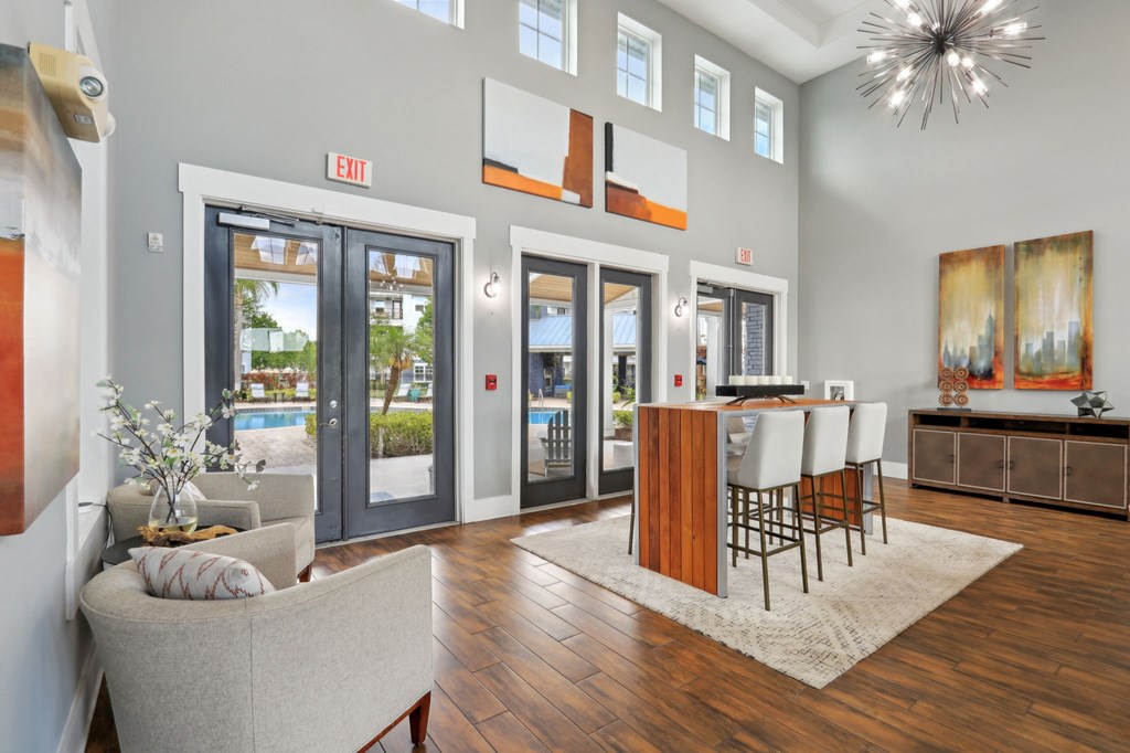 A living room with a couch, chairs, and a dining table.