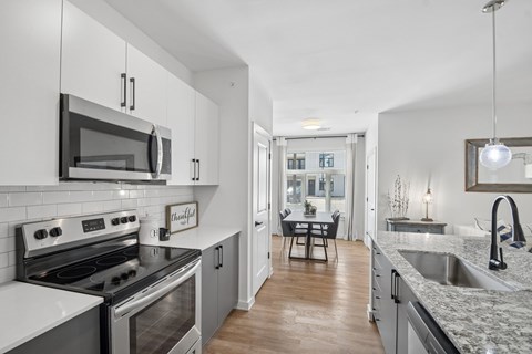 A modern kitchen with a stove top oven and microwave.