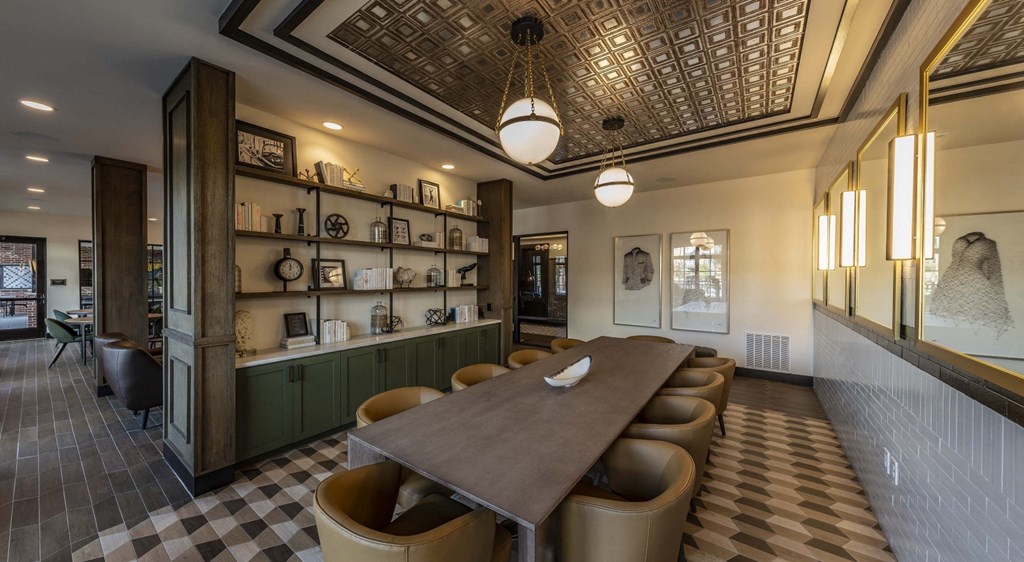 a dining room with a long wooden table and chairs