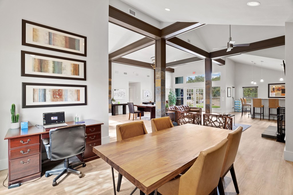 A conference room with a long table and chairs.