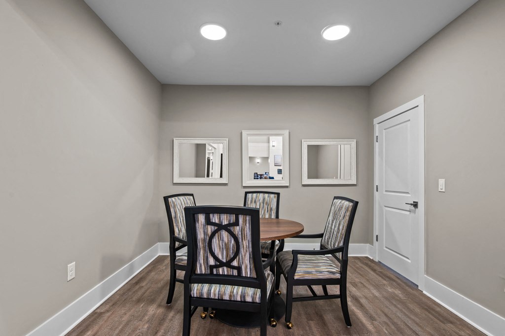 a dining room with a table and chairs