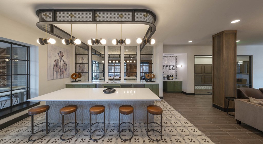 a kitchen with a white counter top and stools