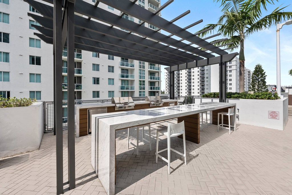a terrace with a table and chairs and a pergola