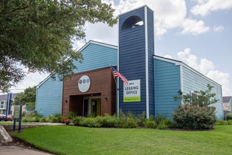 a blue building with a flag in front of it