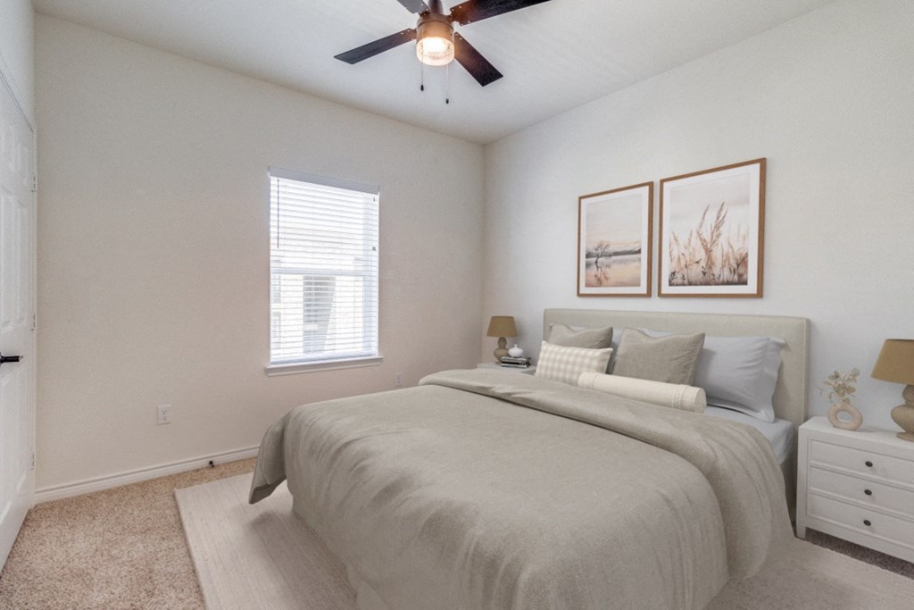an expansive bedroom with a large bed and a ceiling fan