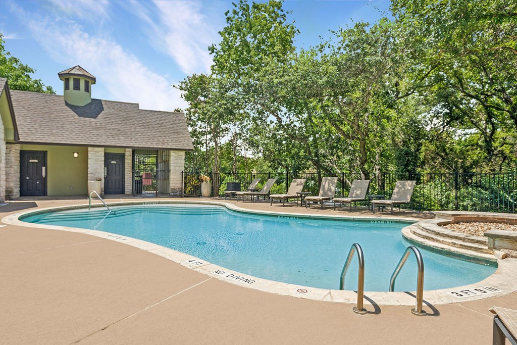 A pool with a small building next to it.