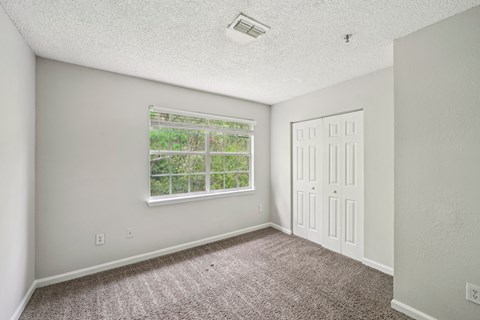 A room with a window and a door.