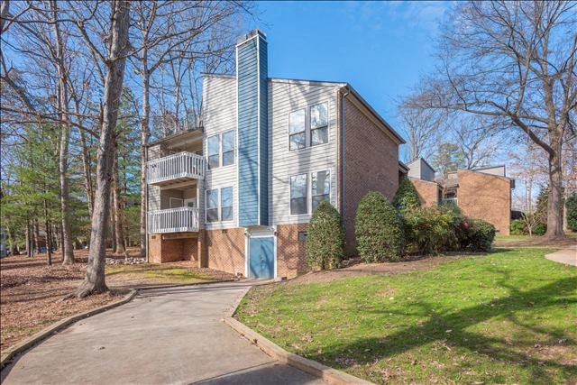 a building with a blue door and a green lawn