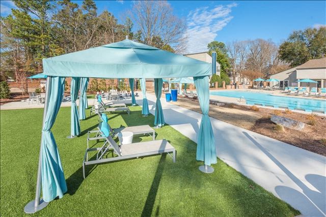 a blue canopy sitting on top of a lush green field
