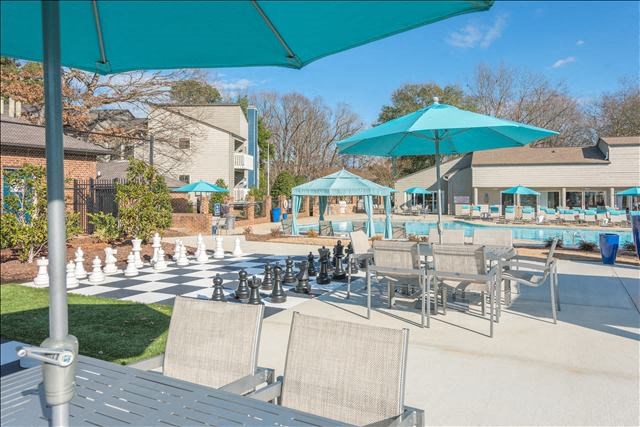 a pool with a bunch of chairs and umbrellas