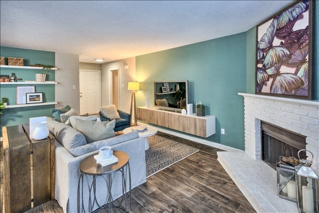 a living room filled with furniture and a fire place