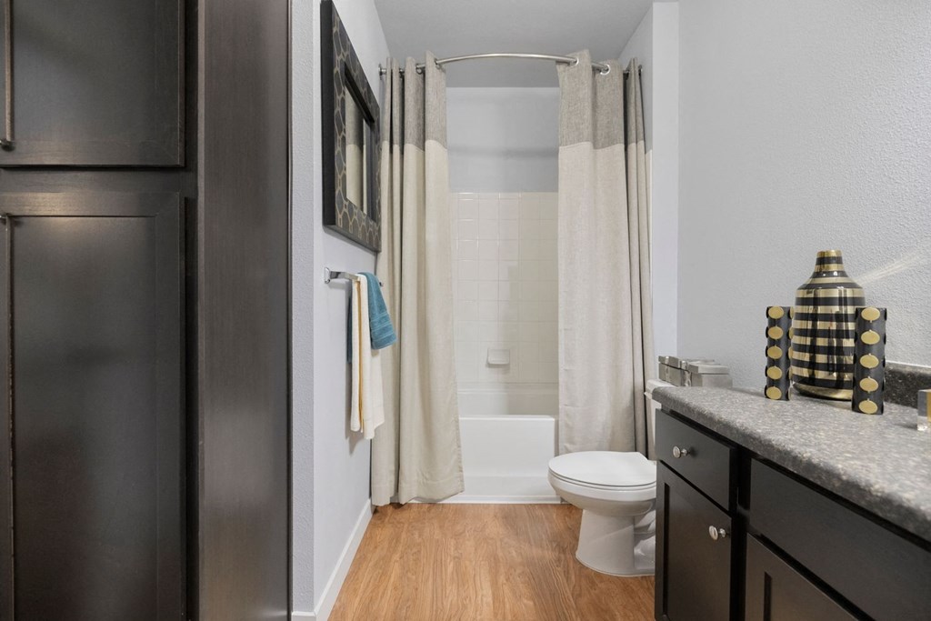 A bathroom with a toilet, sink, and shower.