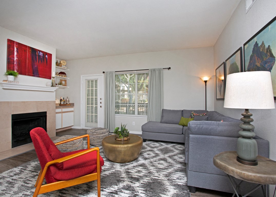 a living room with a couch and a chair and a fireplace
