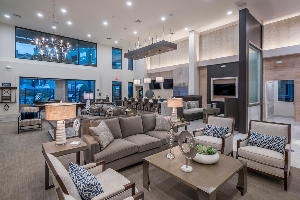 a large living room with couches and chairs and a table