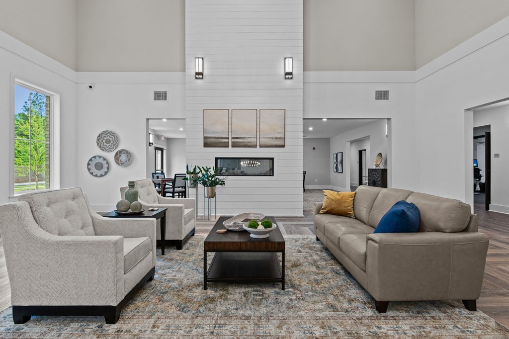 a living room with couches and chairs and a fireplace