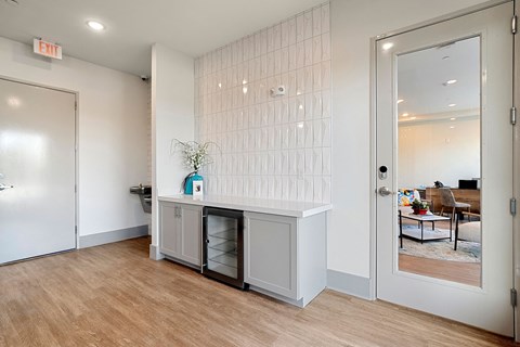 A kitchen with a white cabinet and a plant on top.