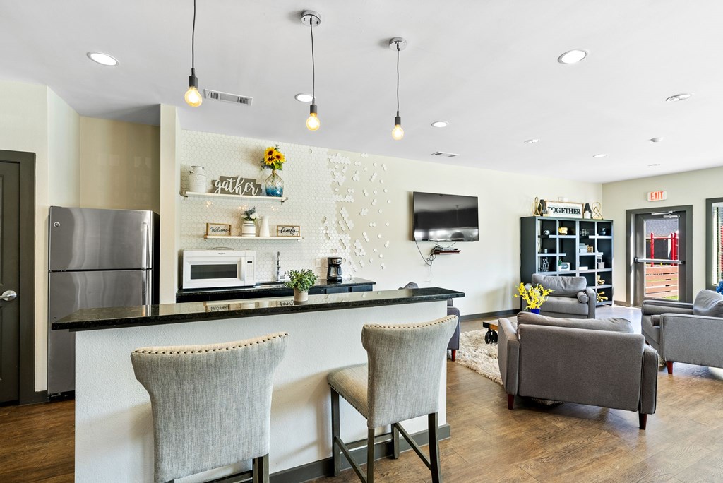A kitchen with a bar area and a dining area.