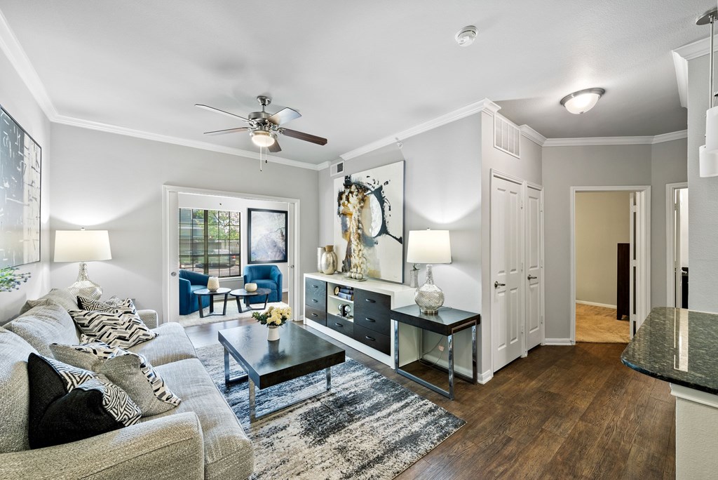 A living room with a grey couch and a coffee table.