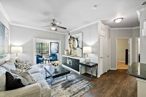 A living room with a grey couch and a coffee table.