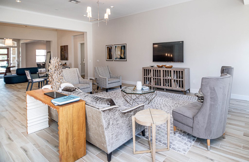 a living room with couches and chairs and a tv