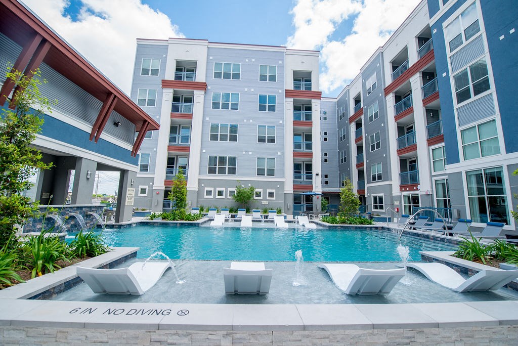 a swimming pool in front of an apartment building