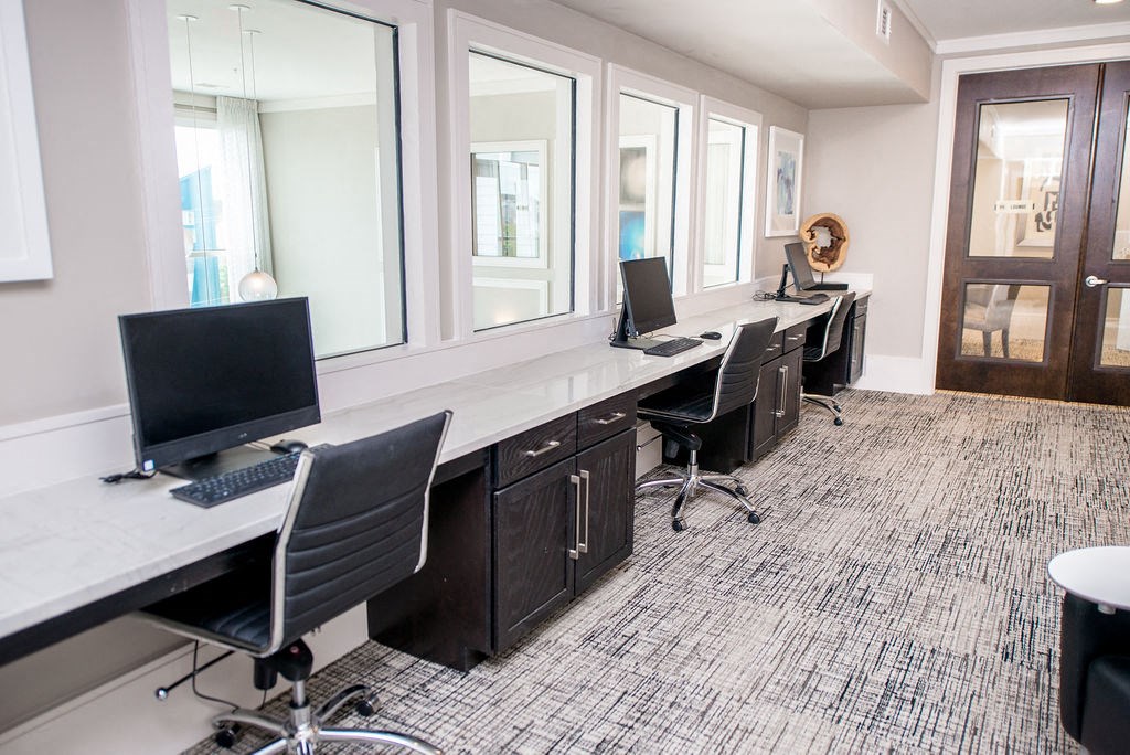 a large office with desks and chairs with computers
