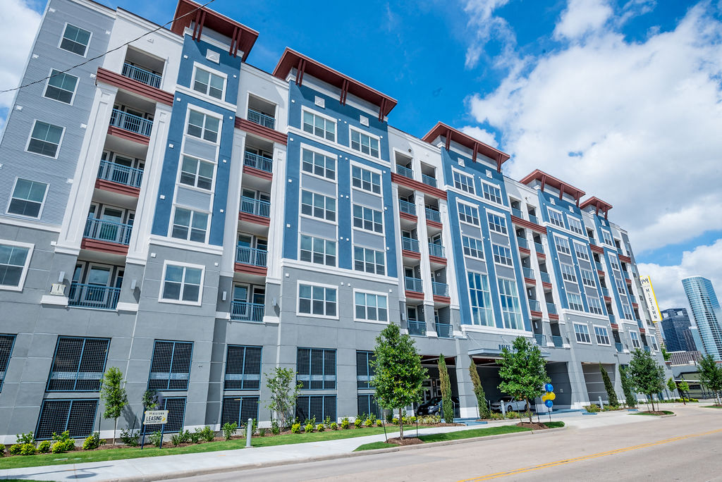 an apartment building with a street in front of it
