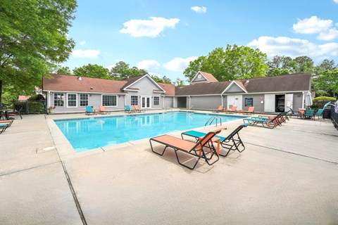 A pool with a building behind it.