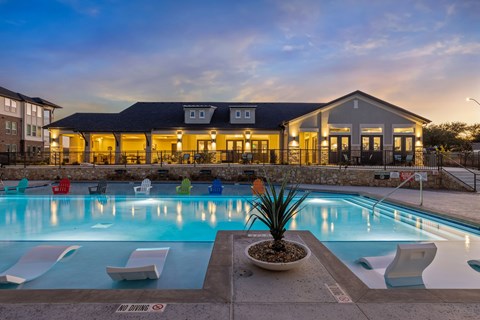 A pool with a building behind it.
