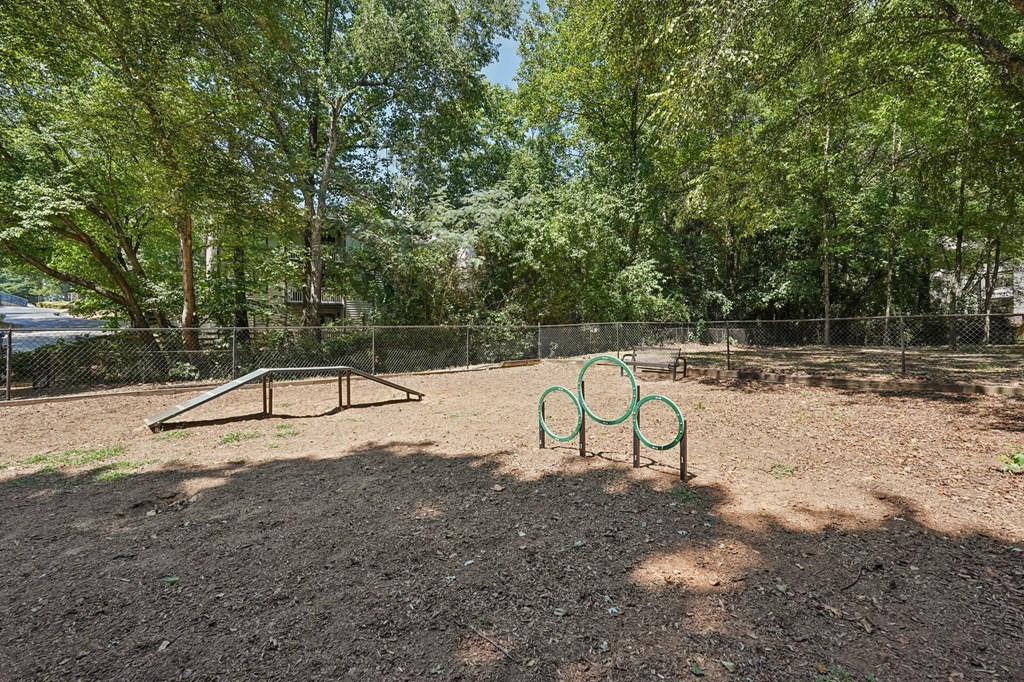A playground with a swing set and a seesaw.