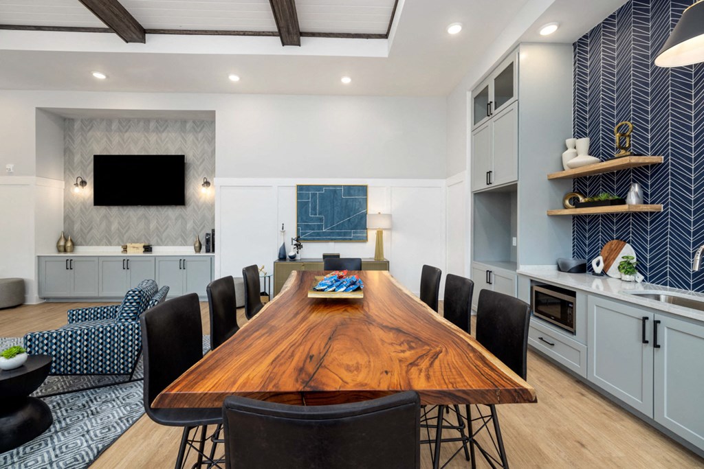 a dining room with a wooden table and black chairs