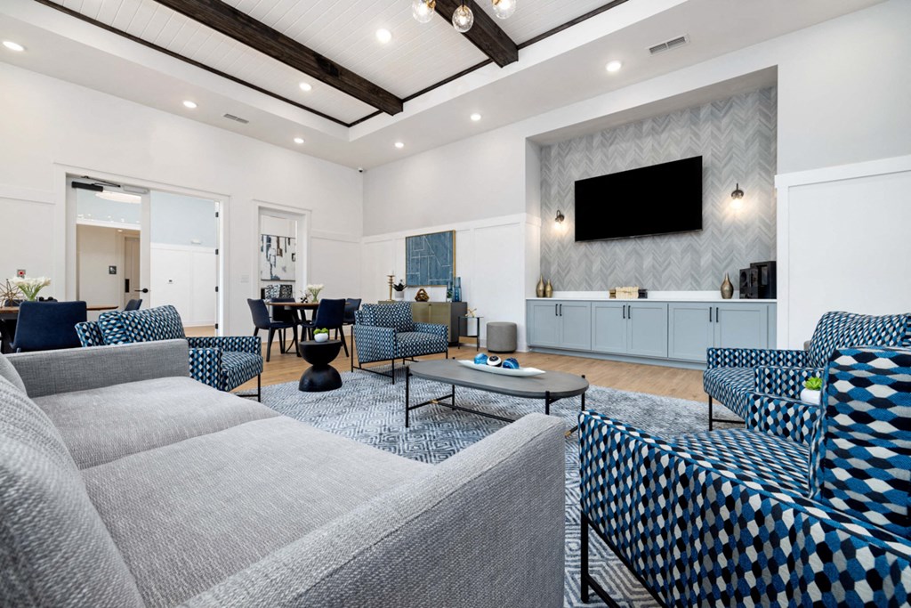 a living room with blue and white furniture and a television