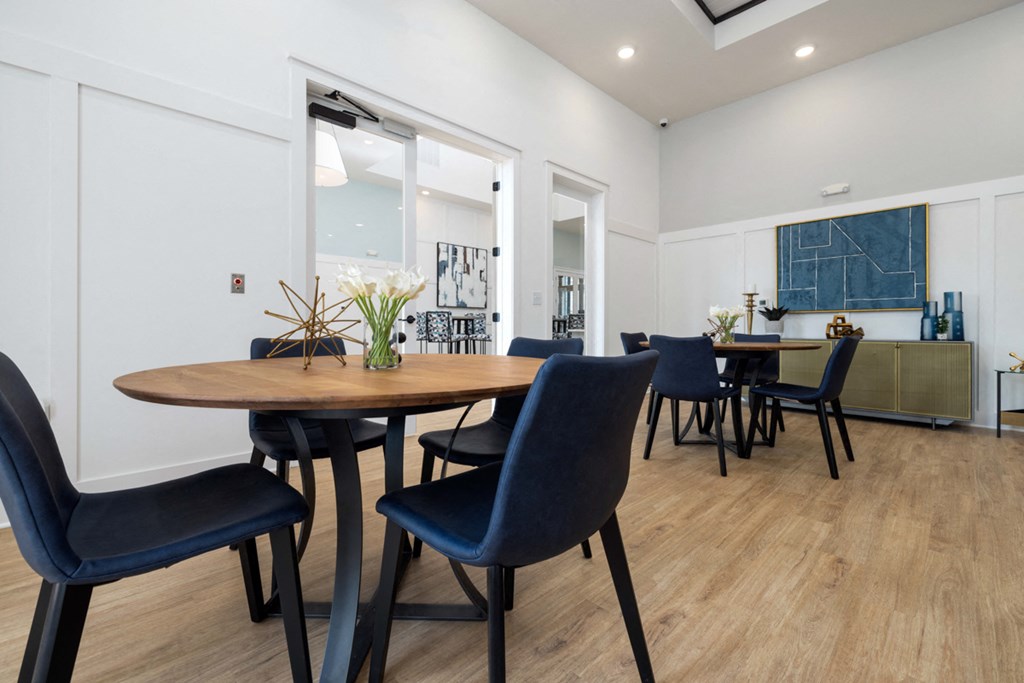 a dining room with a wooden table and blue chairs