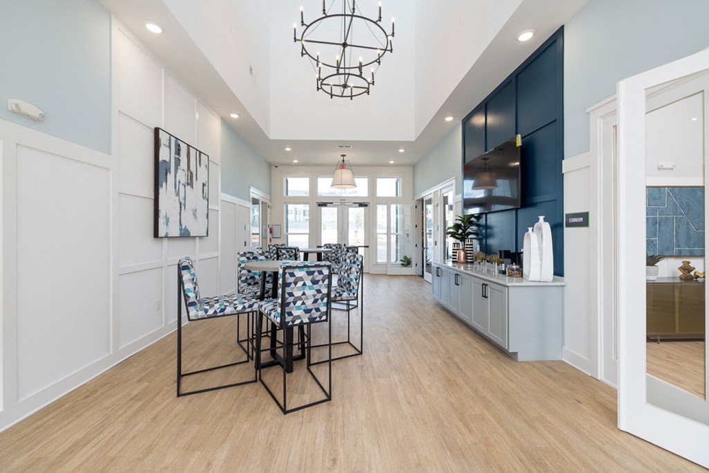 a dining room with a table and chairs and a kitchen