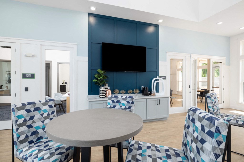 a living room with blue and white chairs and a table