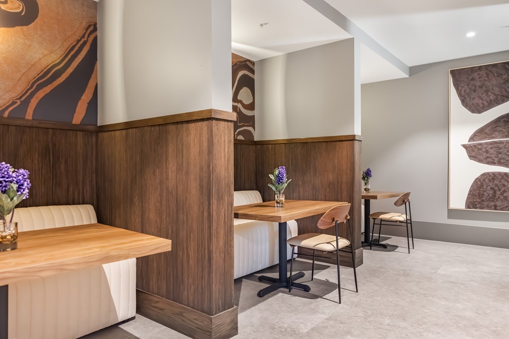 A dining area with a wooden table and chairs.