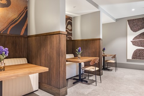 A dining area with a wooden table and chairs.