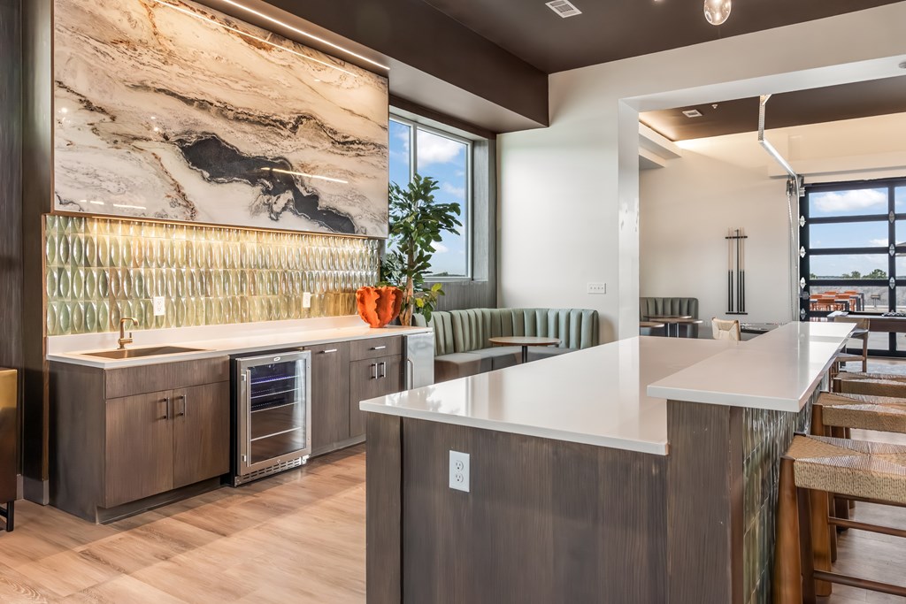 A modern kitchen with a marble backsplash and stainless steel appliances.