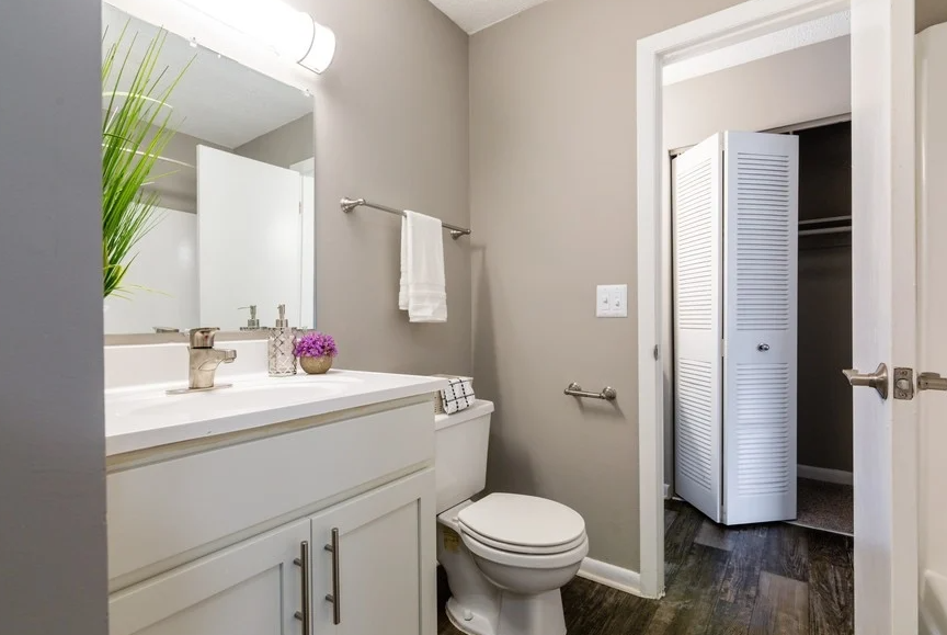a bathroom with a white toilet next to a white sink