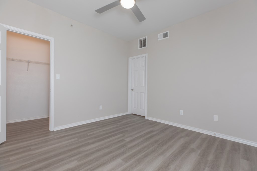 a bedroom at the whispering winds apartments in pearland, tx