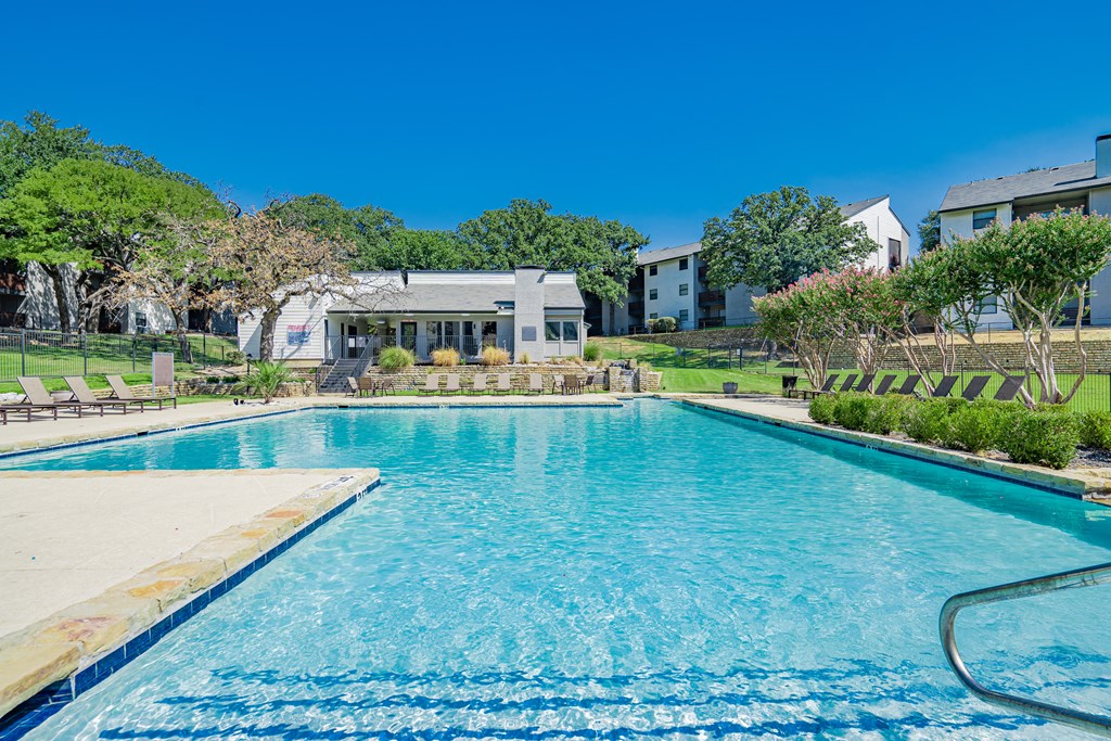 a swimming pool with a house in the background