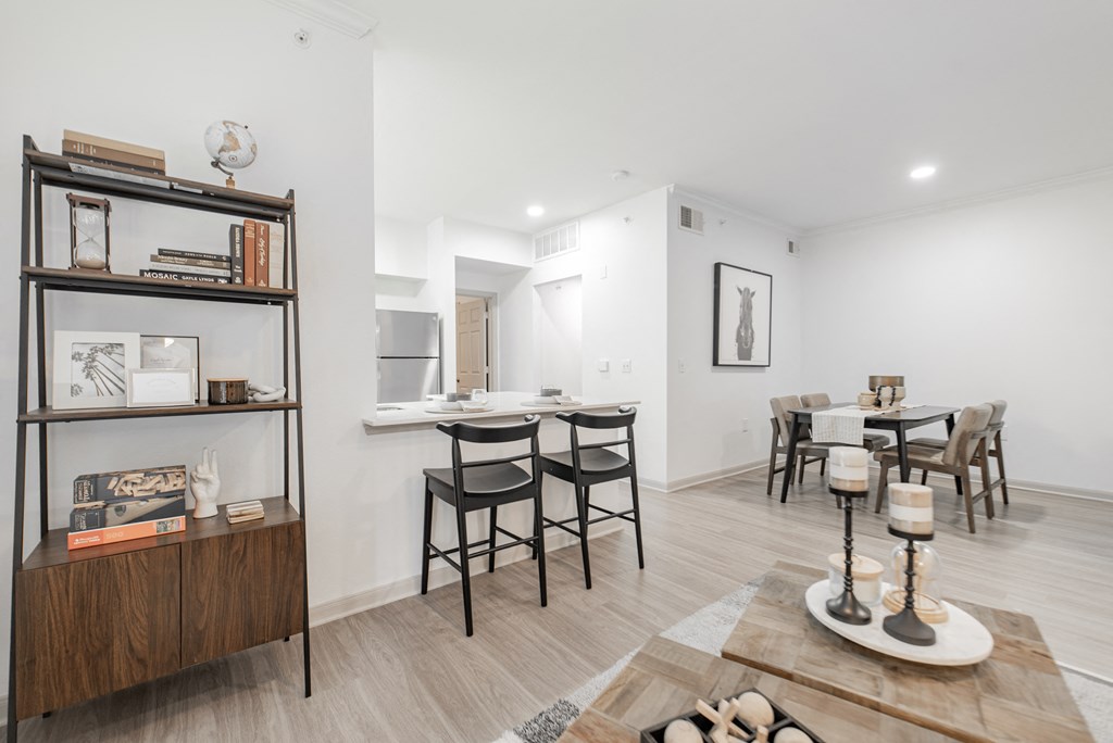 a living room and dining room with a table and chairs