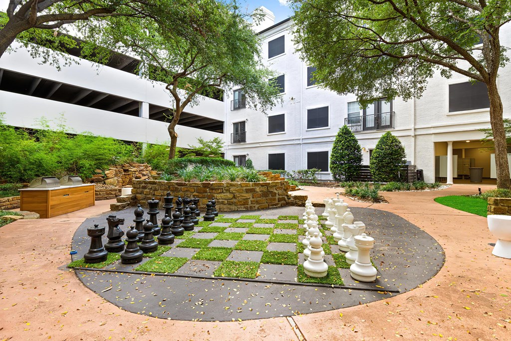 a large chess board in the courtyard of an apartment building