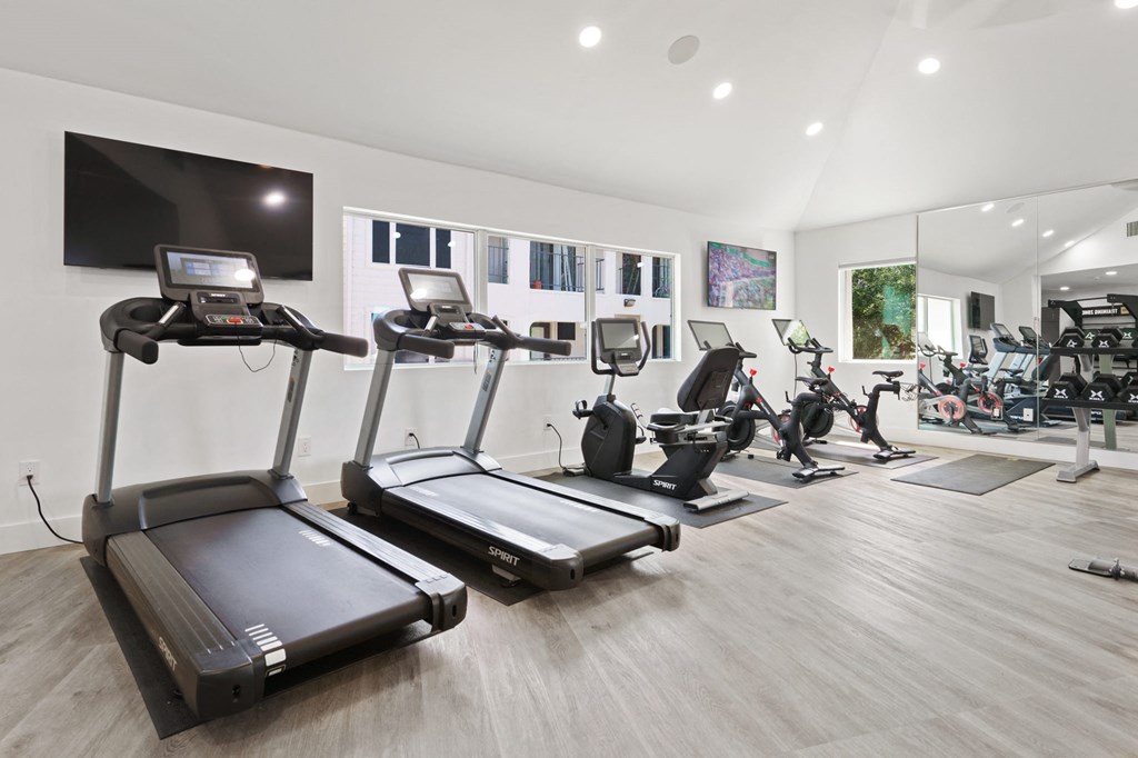 a gym with treadmills and other exercise equipment