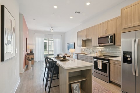 A modern kitchen with a dining table and chairs.