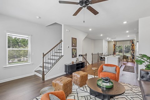 A living room with a brown coffee table and orange chairs.