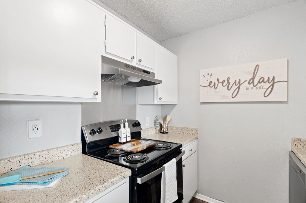 A kitchen with a stove top oven and a sign that says "every day".