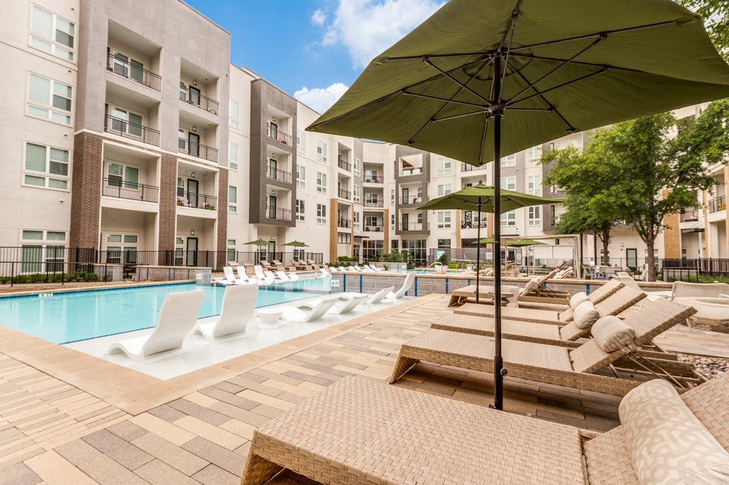 a pool with lounge chairs and umbrellas at the bradley braddock road station